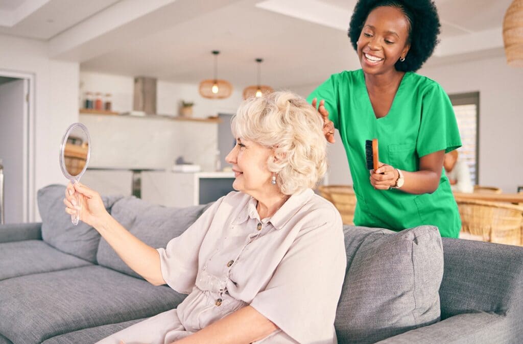 Caregiver with smiling senior at home